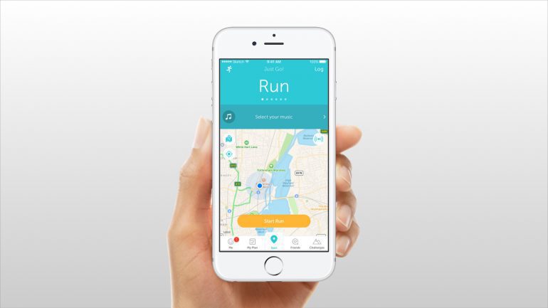 A hand holding an iPhone with the Runkeeper iOS App on screen